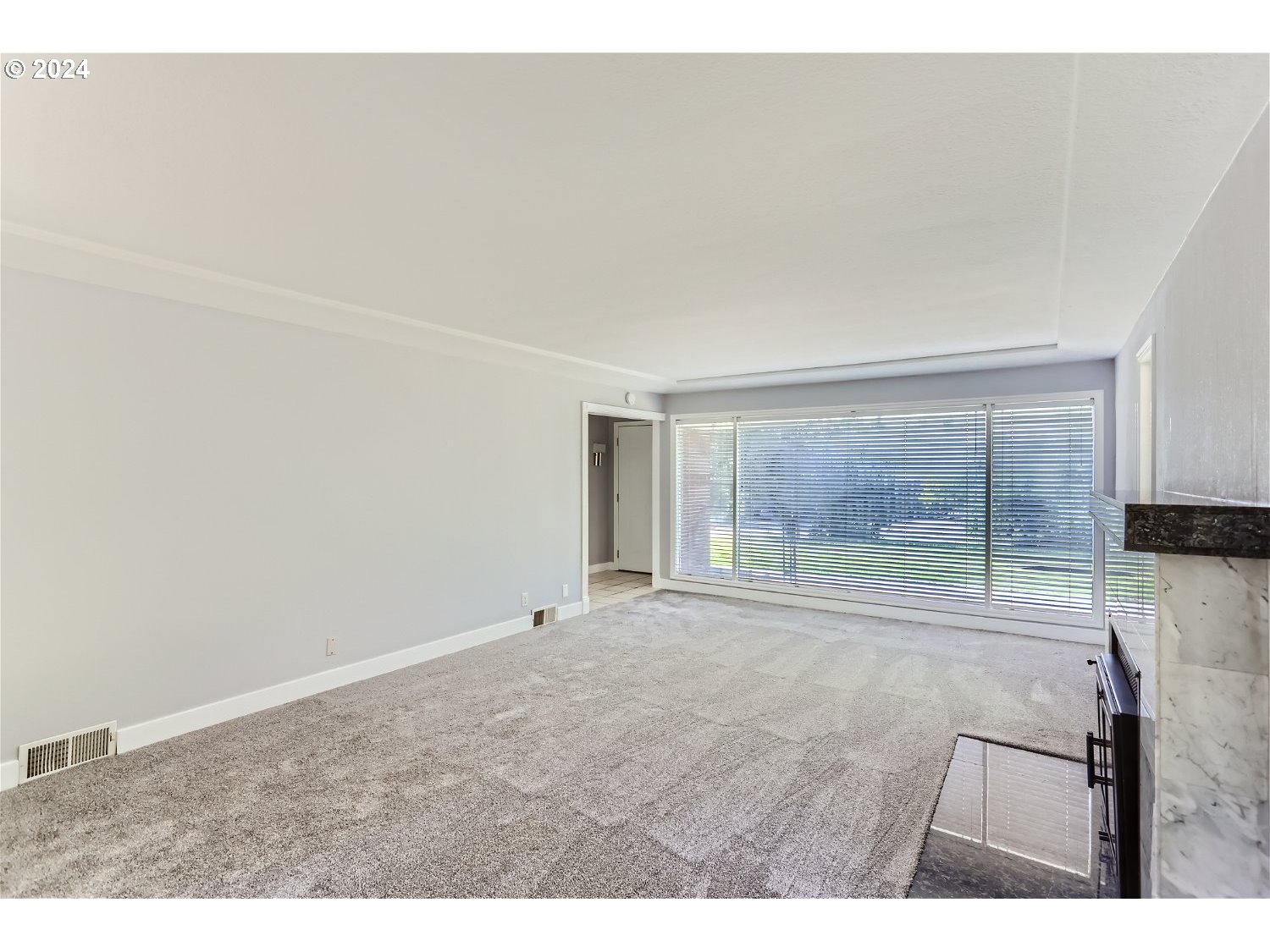 9386 Southwest 35th Avenue Portland, OR 97219 - Photo 7 of 29 a view of an empty room with a fireplace