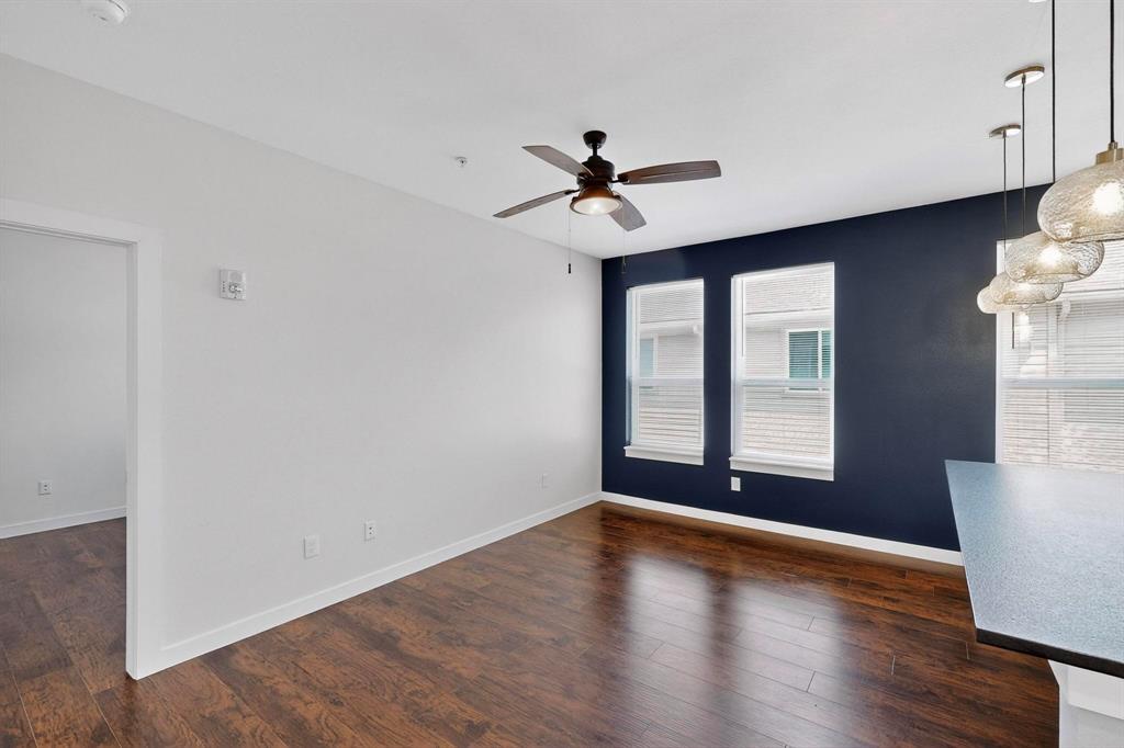 800 South Welch Street, Unit 104 Denton, TX 76201 - Photo 4 of 17 a view of empty room with wooden floor and fan