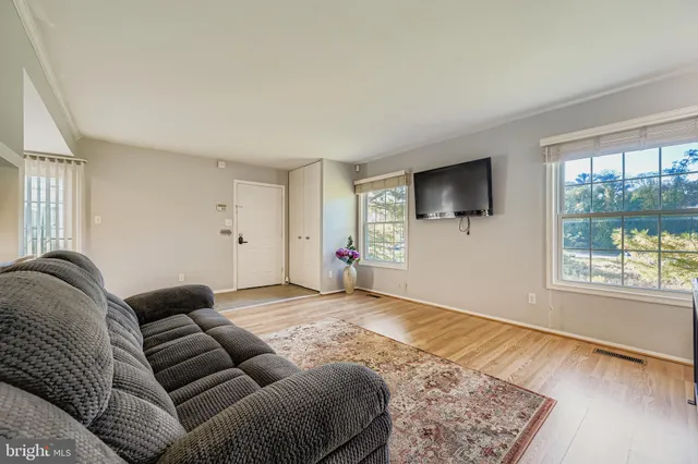 a bed room with a bed a couch and a window