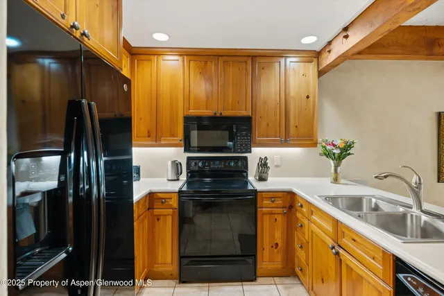 a bathroom with a granite countertop sink a mirror and a shower