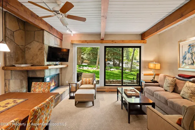 a living room with furniture a fireplace and a table