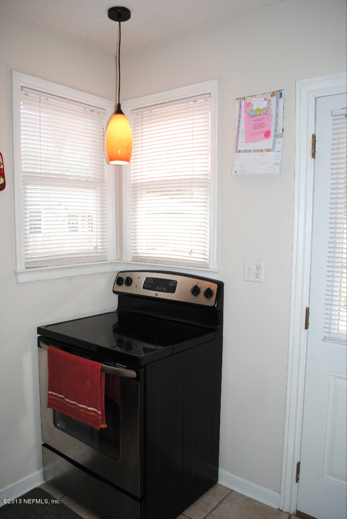 1717 Planters Road Jacksonville, FL 32207 - Photo 8 of 24 a kitchen with stainless steel appliances granite countertop a stove a sink and a window