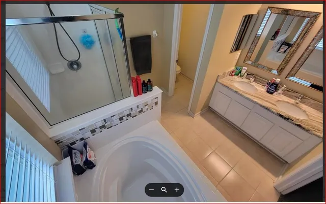 a bathroom with a tub sink and mirror