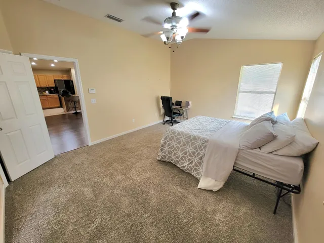 a bedroom with a bed furniture and a wooden floor