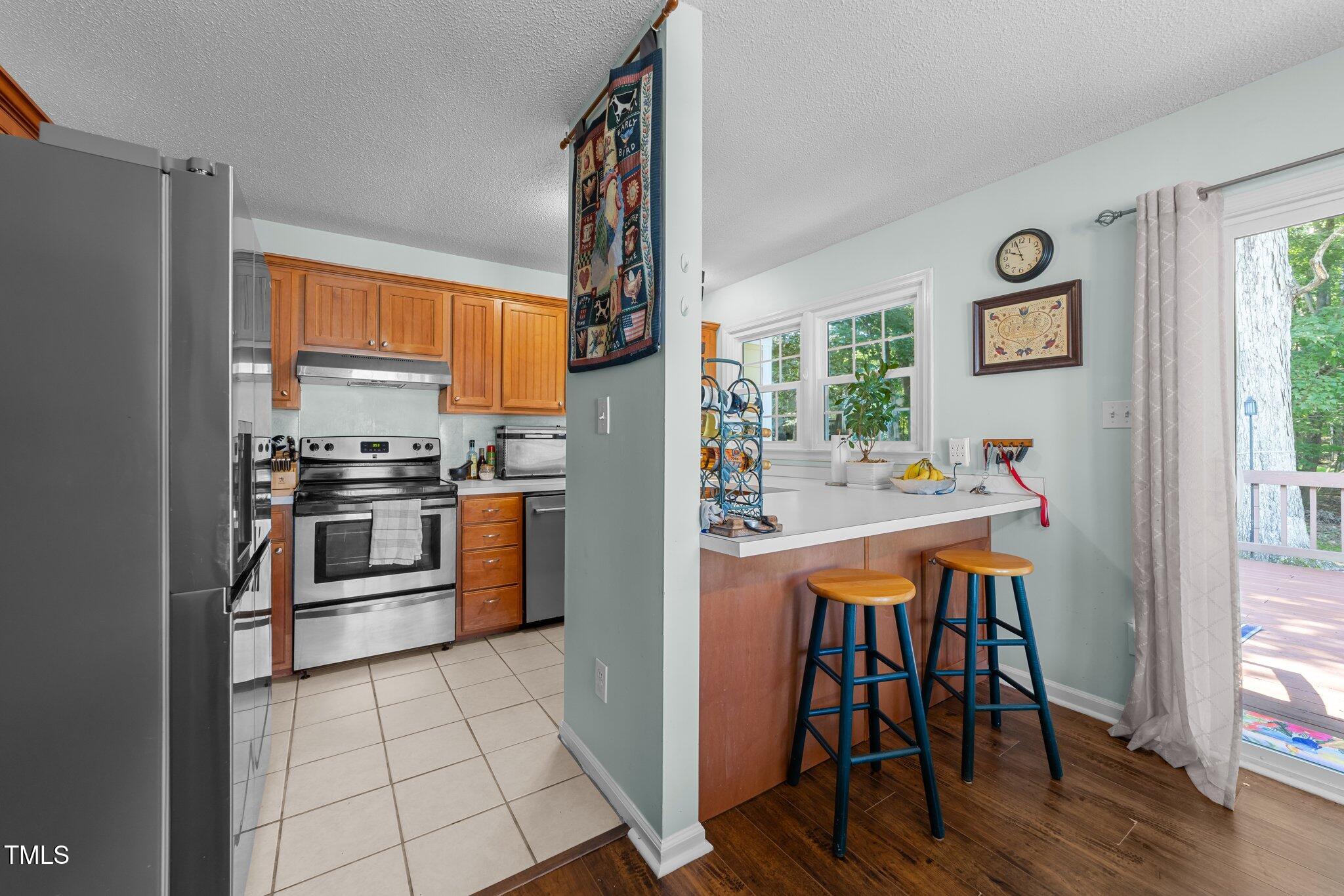 11901 North North Exeter Way Way Raleigh, NC 27613 - Photo 12 of 39 a kitchen with stainless steel appliances a stove a sink and a refrigerator