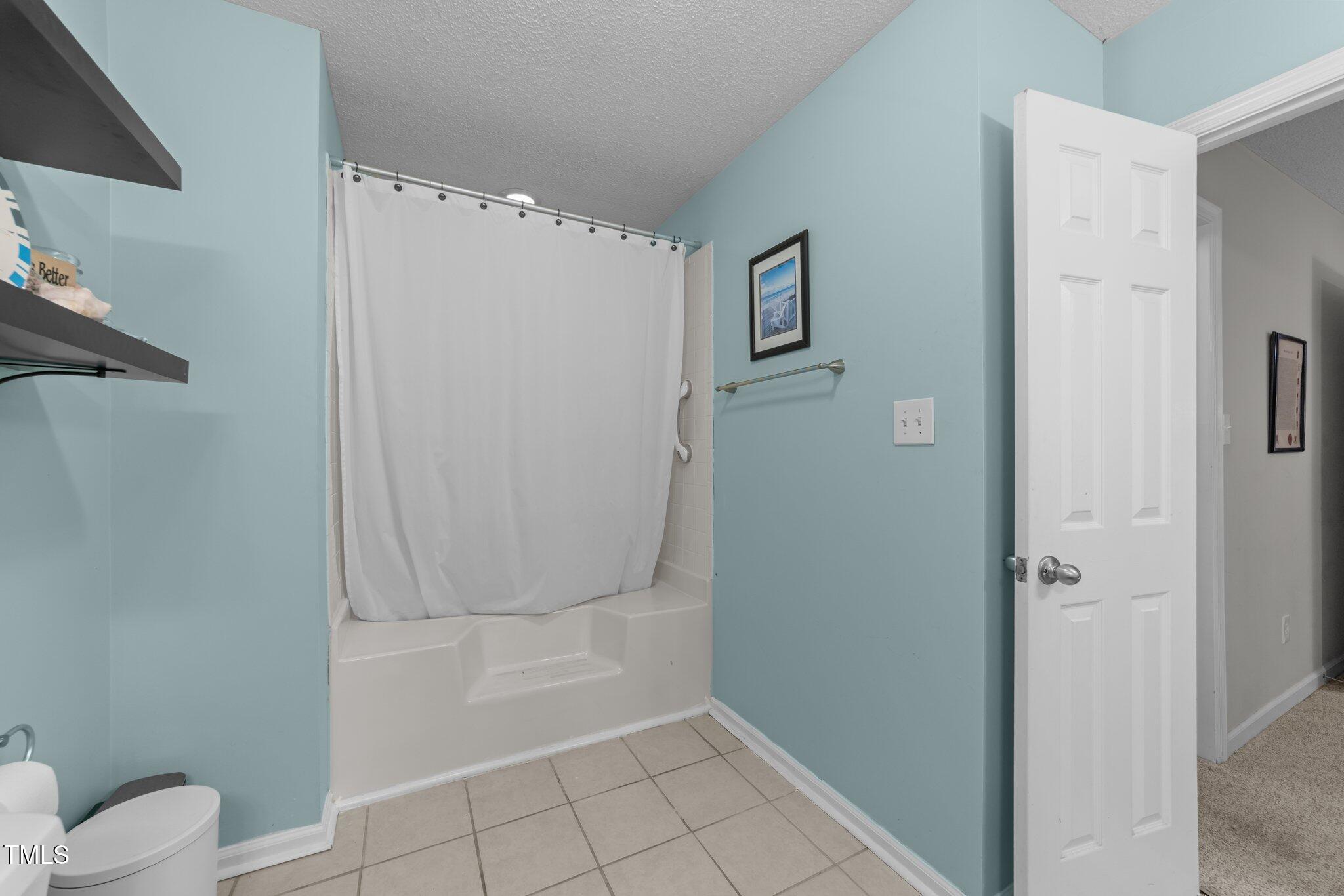 11901 North North Exeter Way Way Raleigh, NC 27613 - Photo 16 of 39 a bathroom with a shower and toilet