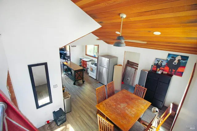 a view of a dining room with furniture wooden floor and front door