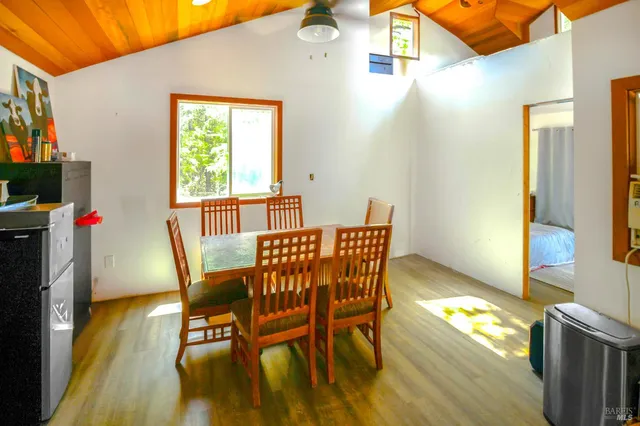 a view of a dining room with furniture and a window