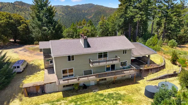 an aerial view of a house with a yard