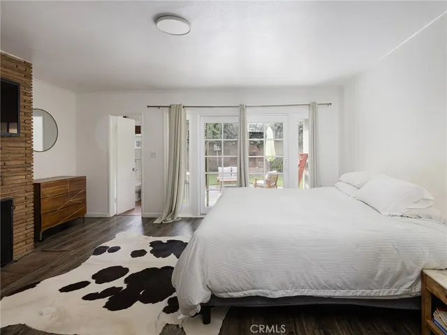a bedroom with a bed a dresser and a large mirror