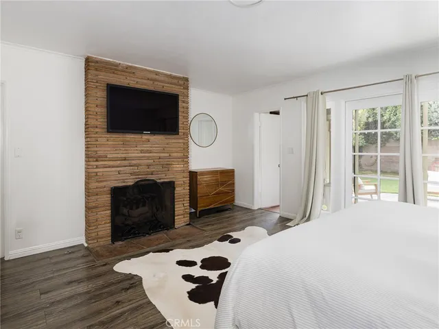 a bedroom with a bed and a fireplace