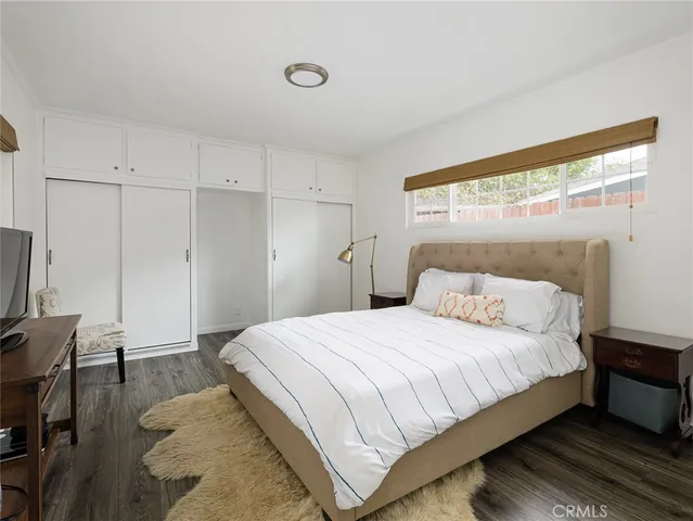 a bedroom with a bed and a desk