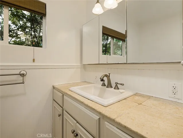 a bathroom with a sink and a window