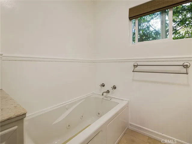 a bathroom with a bathtub and window