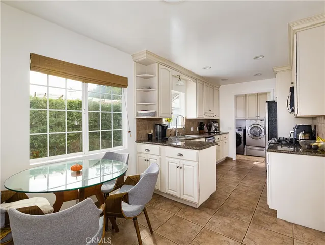a kitchen with stainless steel appliances kitchen island granite countertop a sink and cabinets