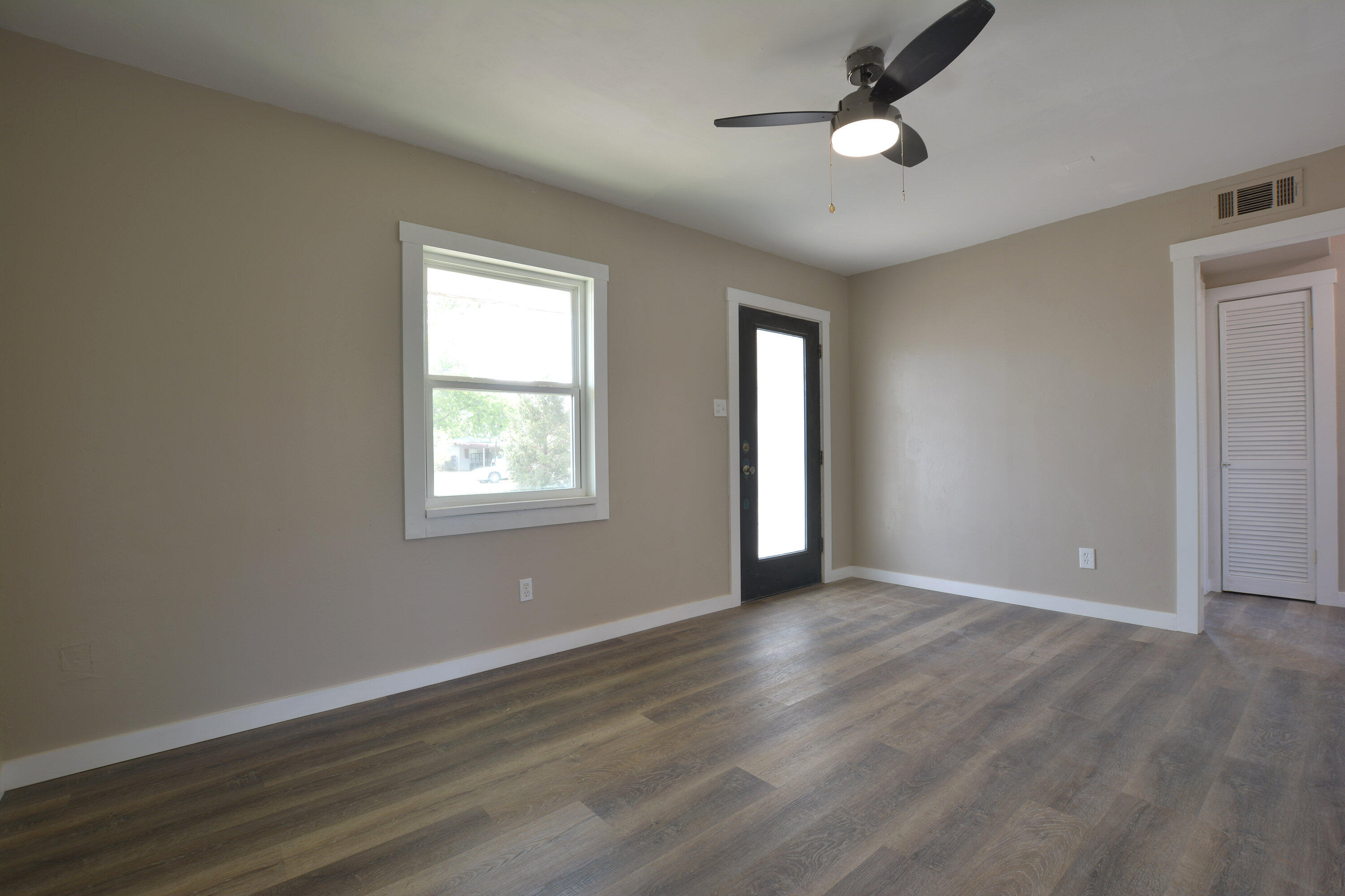 4608 Detroit Avenue Lubbock, TX 79413 - Photo 5 of 20 a view of an empty room with wooden floor and a window