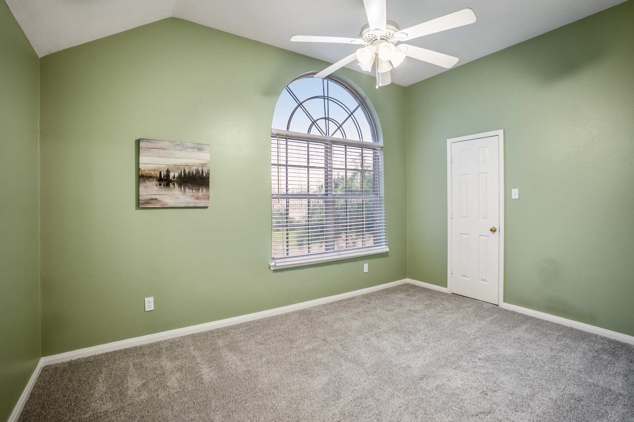 6311 Sparrows Glen Lane Spring, TX 77379 - Photo 26 of 50 Just off the gameroom, this upstairs bedroom brings in character with vaulted ceilings, an arched front window, and a tucked closet while staying close to the second-floor bath.