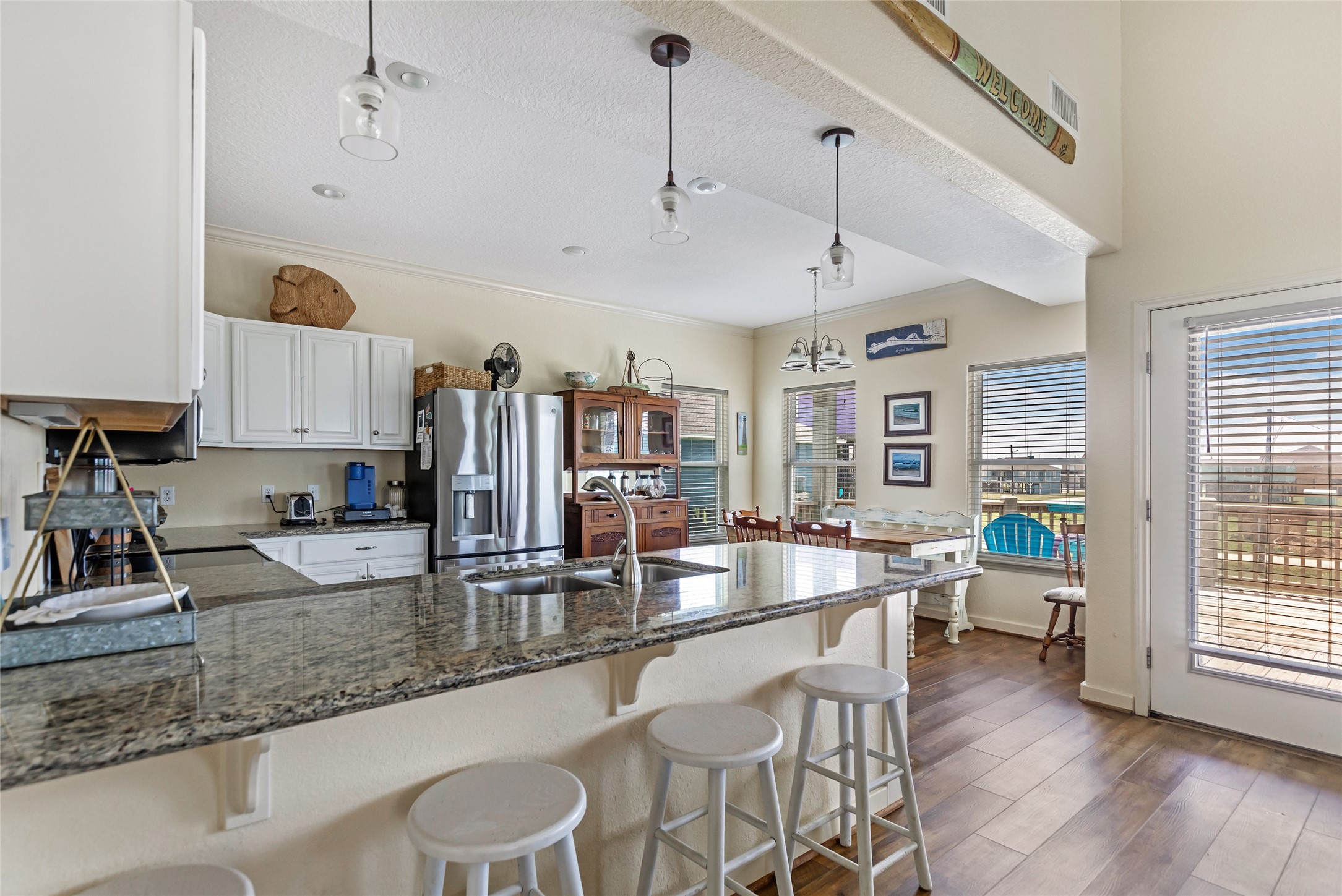 2116 Canal Crystal Beach, TX 77650 - Photo 26 of 45 a kitchen with stainless steel appliances granite countertop a sink and a refrigerator