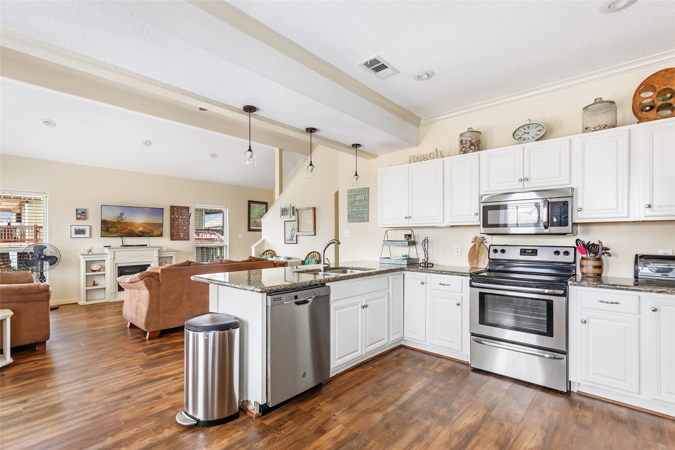 2116 Canal Crystal Beach, TX 77650 - Photo 28 of 45 a kitchen with granite countertop appliances cabinets and wooden floor