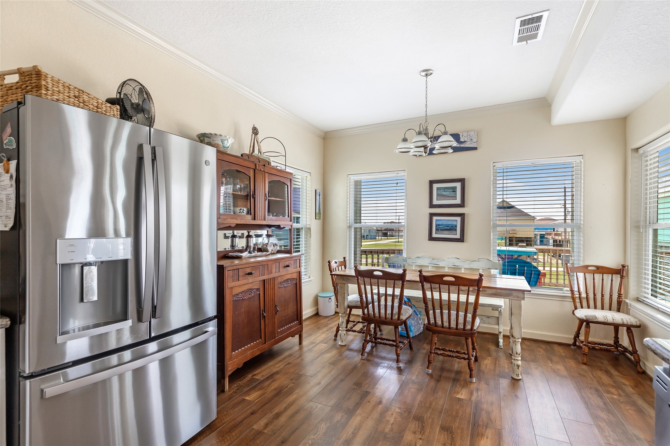 2116 Canal Crystal Beach, TX 77650 - Photo 29 of 45 a kitchen with stainless steel appliances wooden floor and dining table