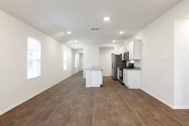 a view of kitchen with refrigerator and window