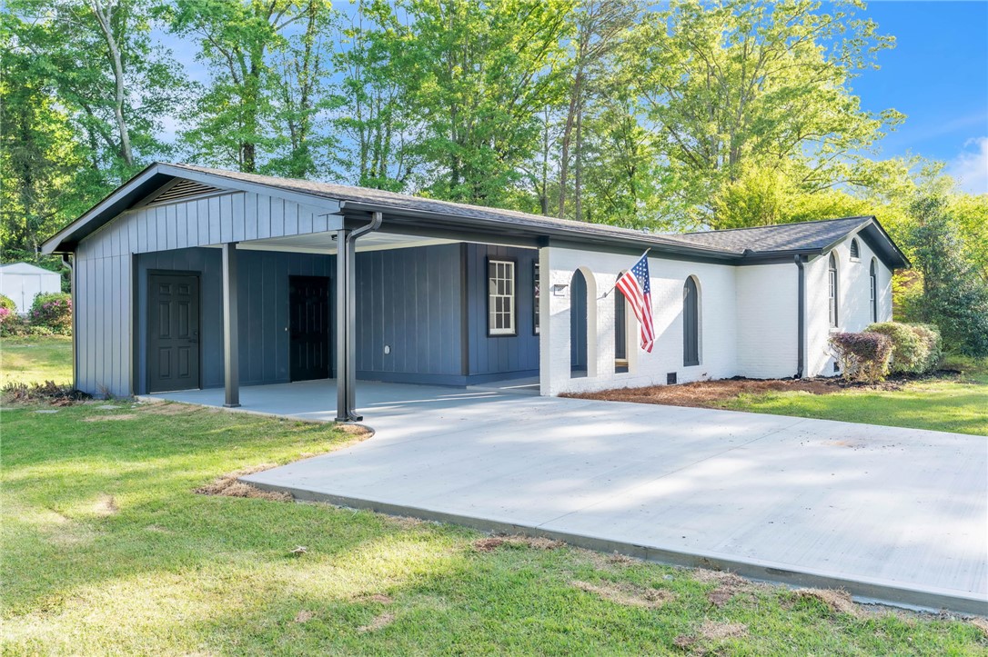 403 Keith Lane Seneca, SC 29678 - Photo 3 of 28 This charming home offers a convenient carport and lush green surroundings.