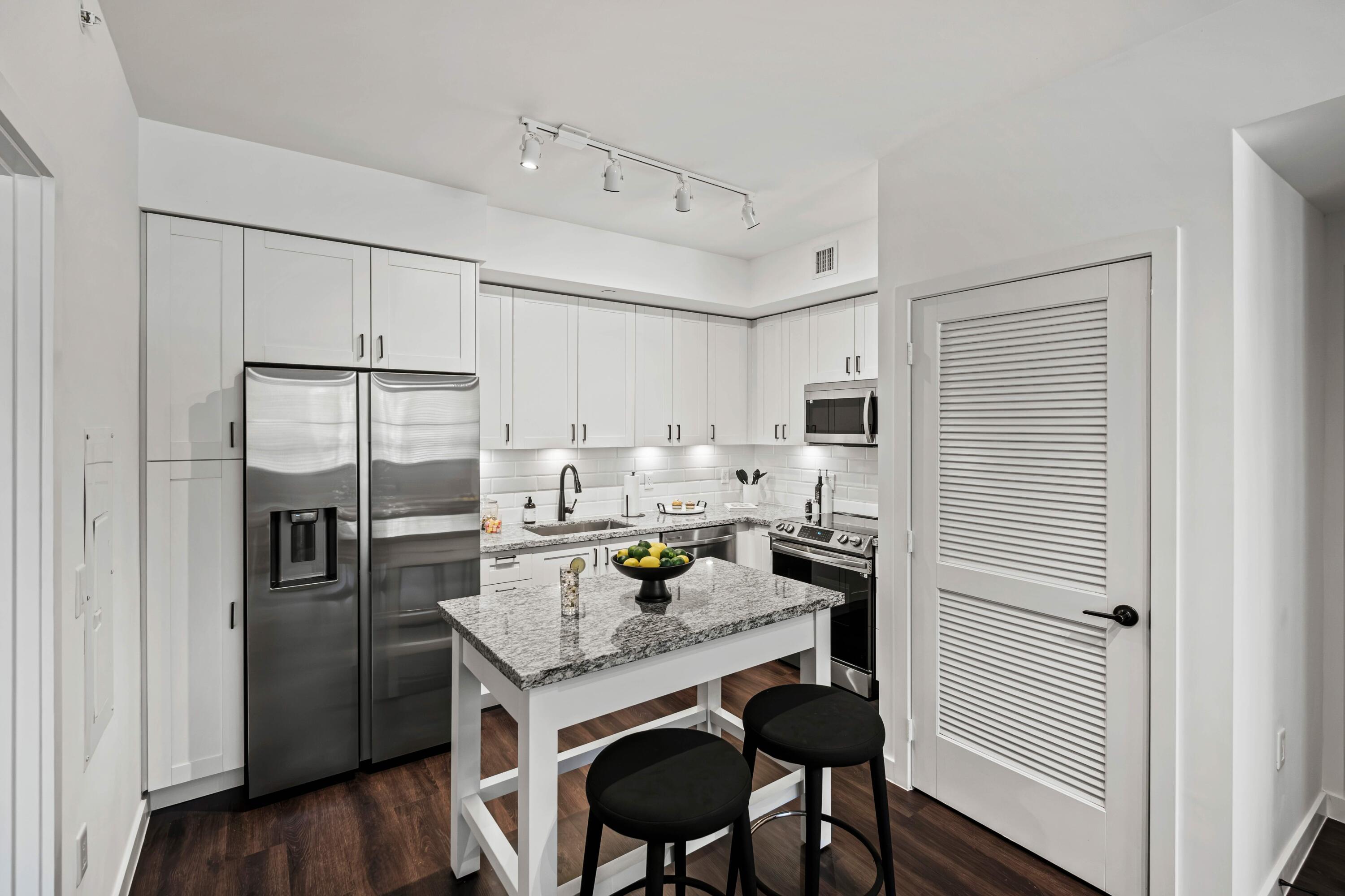 2000 Stirling Road, Unit 3204 Hollywood, FL 33020 - Photo 17 of 35 a kitchen with refrigerator cabinets and wooden floor