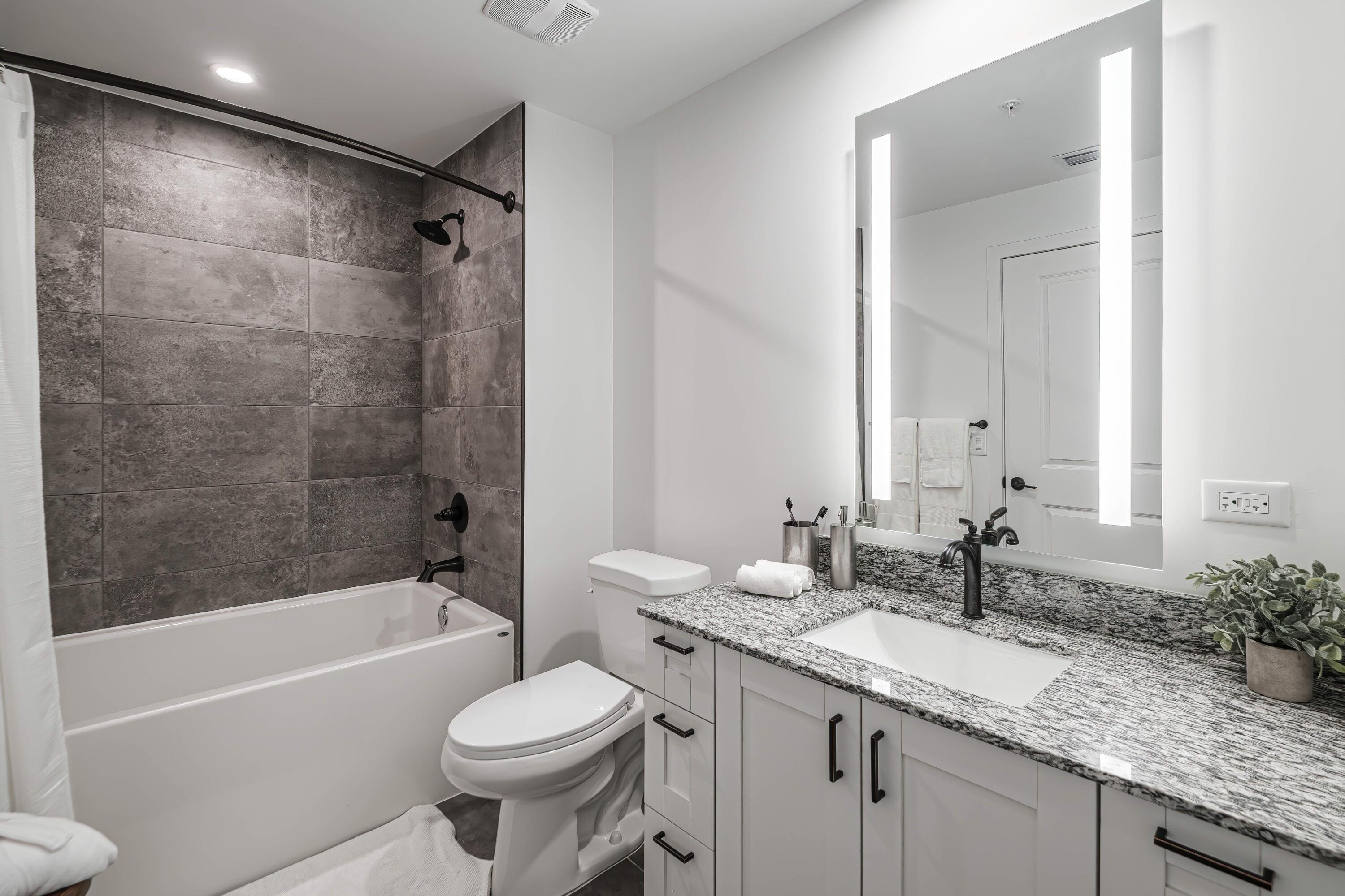 2000 Stirling Road, Unit 3204 Hollywood, FL 33020 - Photo 18 of 35 a bathroom with a granite countertop sink toilet and shower