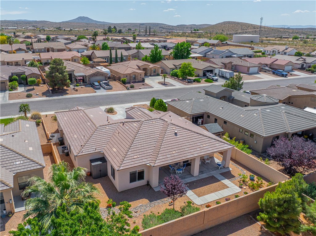 3315 Rainbow Mine Road Kingman, AZ 86401 - Photo 43 of 54 This property features a covered patio, a well-maintained yard with mature landscaping, and a tiled roof