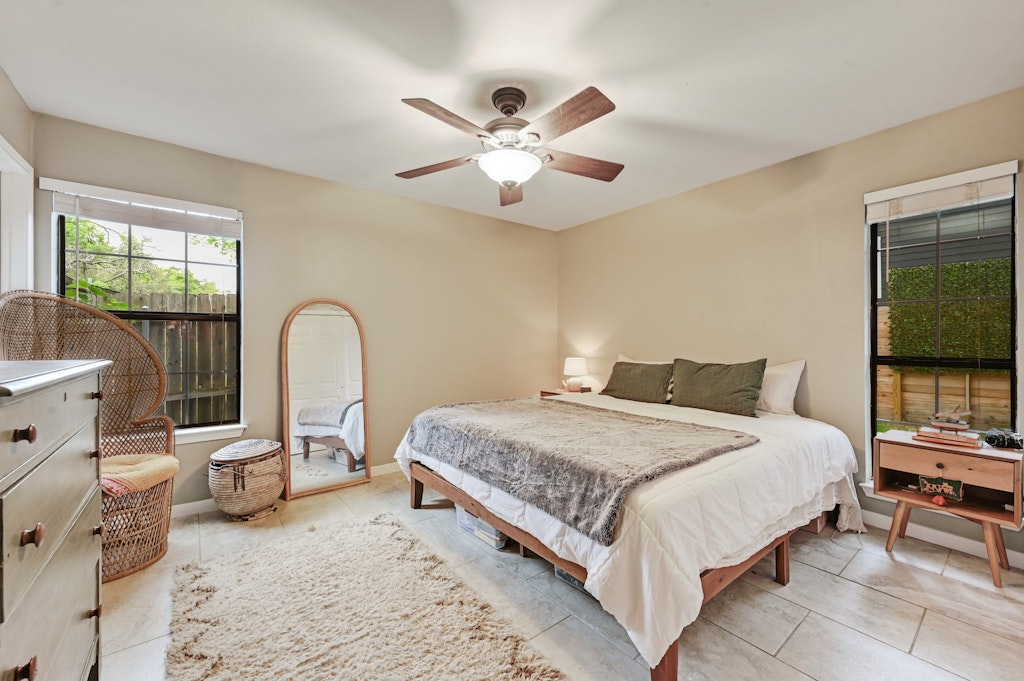 4025 Valley View Road, Unit 2 Austin, TX 78704 - Photo 10 of 19 a bedroom with a bed and a chandelier
