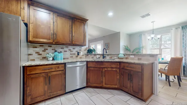 a kitchen with stainless steel appliances granite countertop refrigerator sink and cabinets
