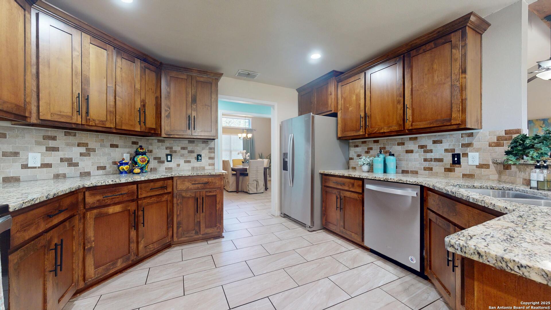 3992 Fm 1784 Pleasanton, TX 78064 - Photo 12 of 38 a kitchen with stainless steel appliances granite countertop refrigerator sink and cabinets
