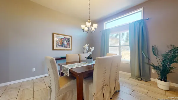 a dining room with furniture and window