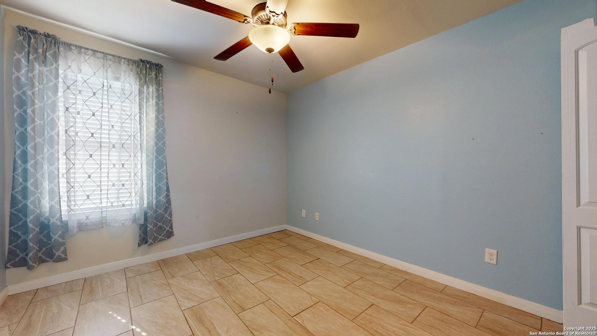 3992 Fm 1784 Pleasanton, TX 78064 - Photo 19 of 38 an empty room with windows and fan
