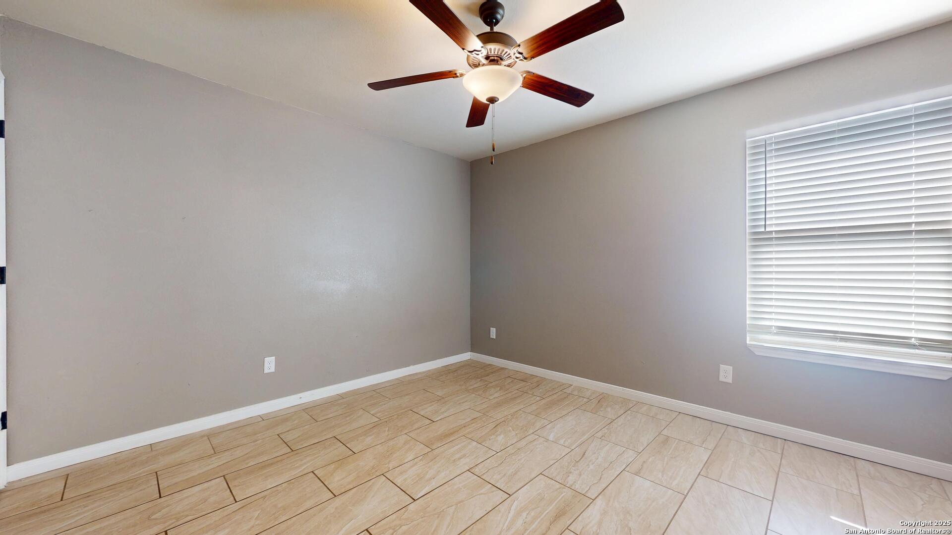 3992 Fm 1784 Pleasanton, TX 78064 - Photo 20 of 38 an empty room with windows and fan