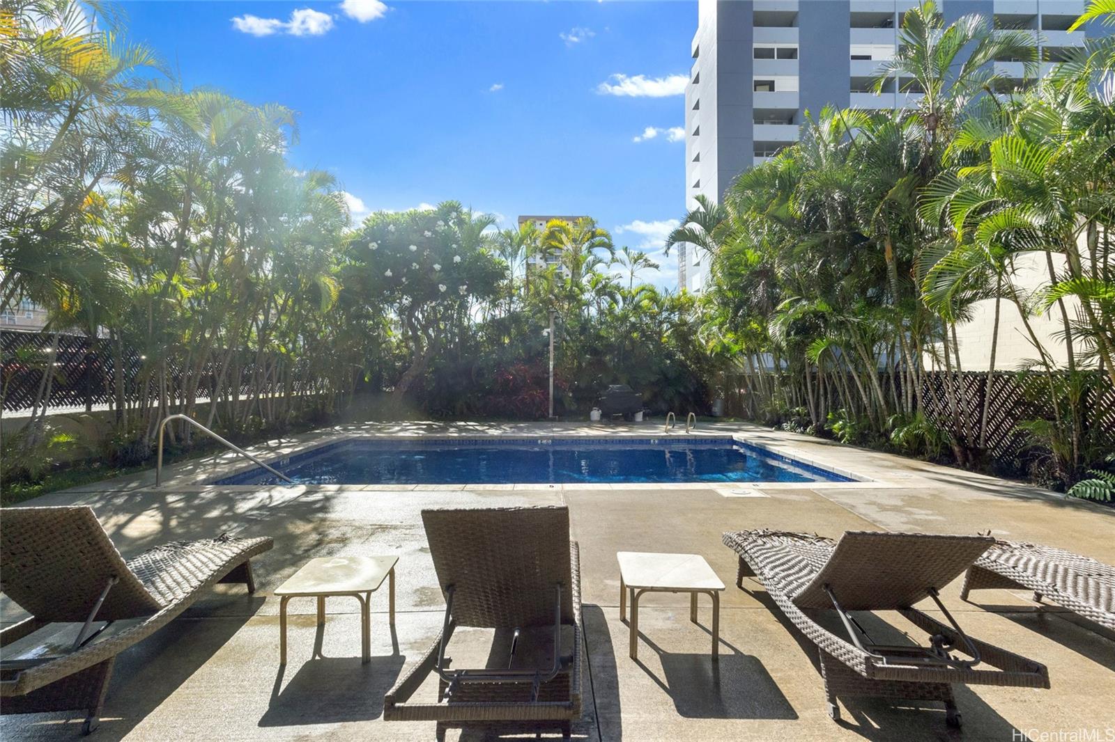 775 Kinalau Place, Unit 1003 Honolulu, HI 96813 - Photo 12 of 25 a view of yard with seating area and trees in the background