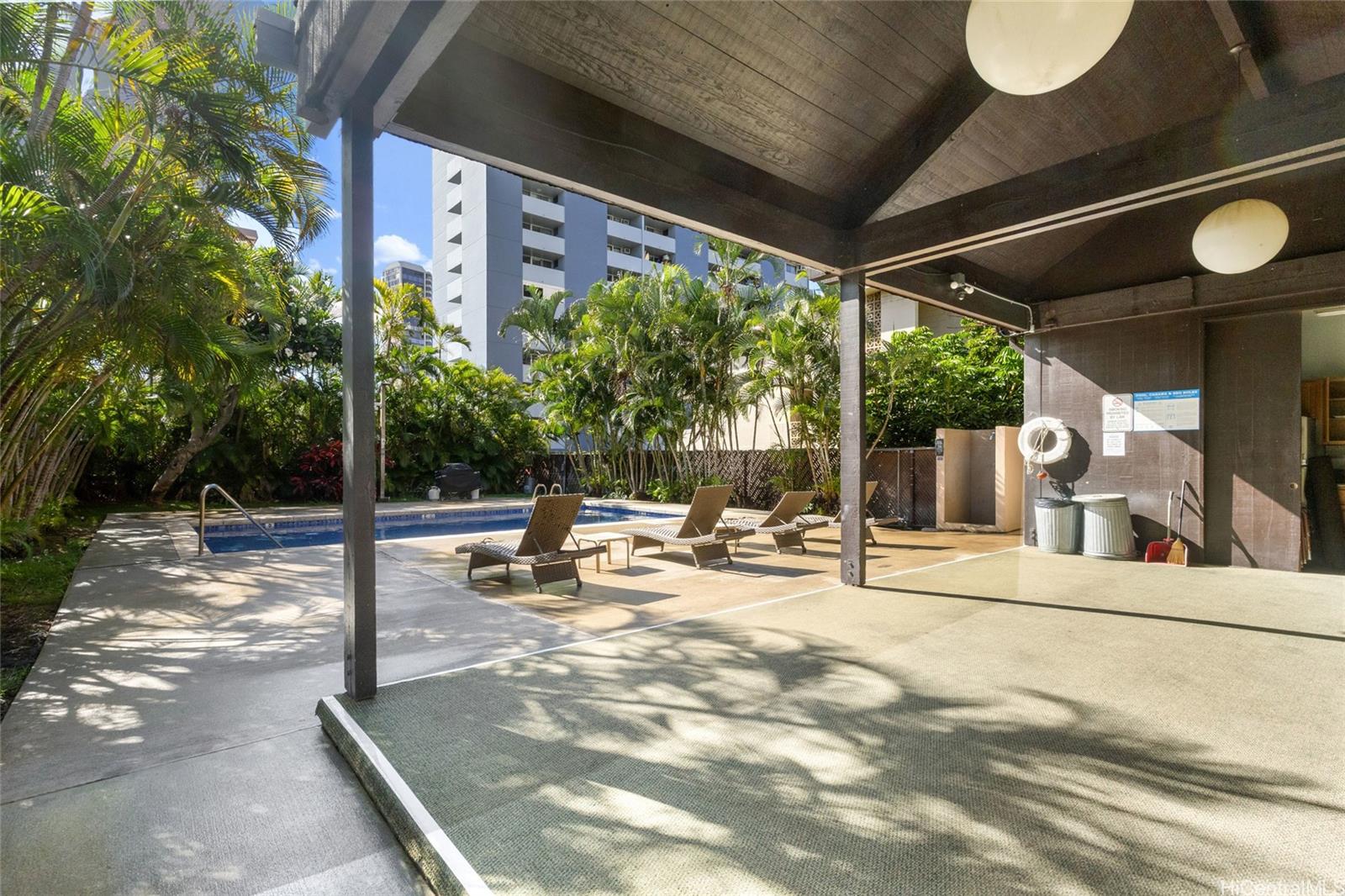 775 Kinalau Place, Unit 1003 Honolulu, HI 96813 - Photo 14 of 25 a view of a swimming pool with a patio