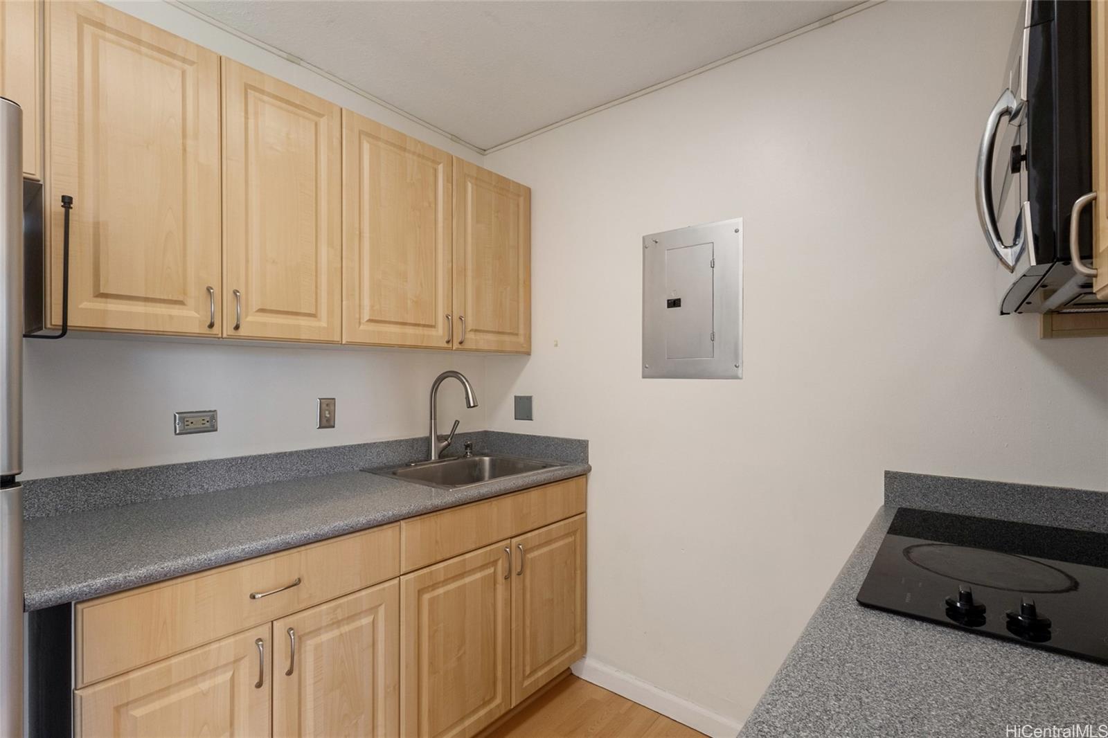 775 Kinalau Place, Unit 1003 Honolulu, HI 96813 - Photo 5 of 25 a kitchen with a sink and cabinets