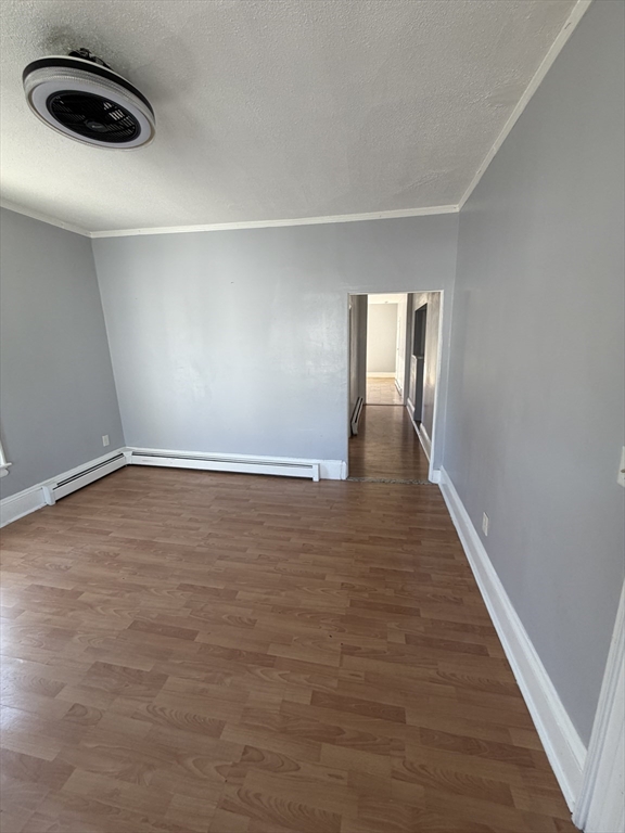 40 Rogers Avenue, Unit 2 Lynn, MA 01902 - Photo 3 of 15 a view of an empty room with wooden floor