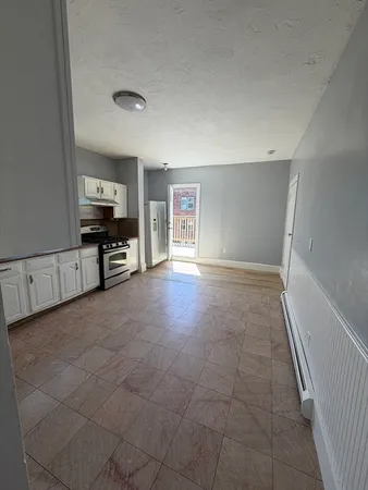 a view of a livingroom with furniture and a window