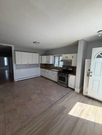 a large kitchen with a stove and a refrigerator