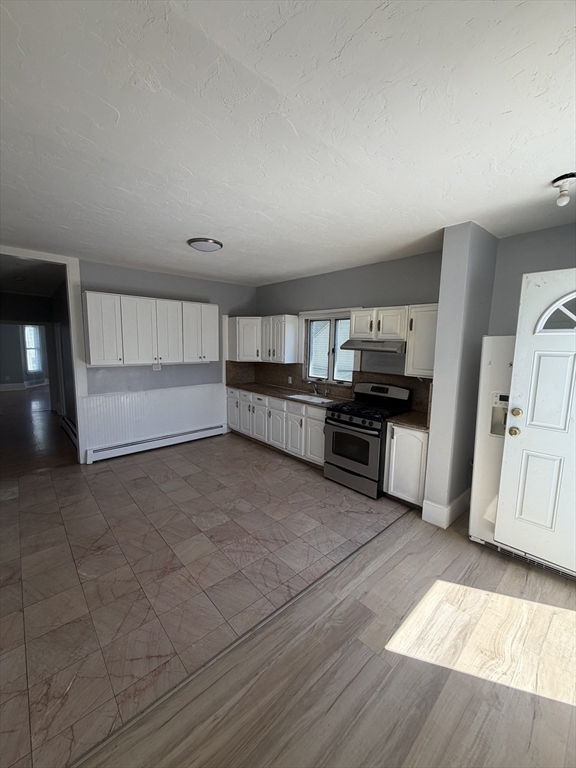 40 Rogers Avenue, Unit 2 Lynn, MA 01902 - Photo 7 of 15 a large kitchen with a stove and a refrigerator