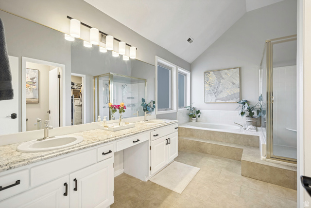 1837 Richard Road Sandy, UT 84093 - Photo 21 of 67 Spacious bathroom featuring a double vanity with stone-finish countertops, an integrated soaking tub, a separate glass-enclosed shower, and vaulted ceilings