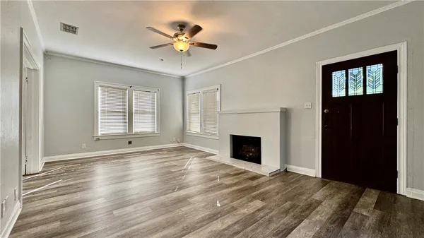 a view of an empty room with a fireplace and a window