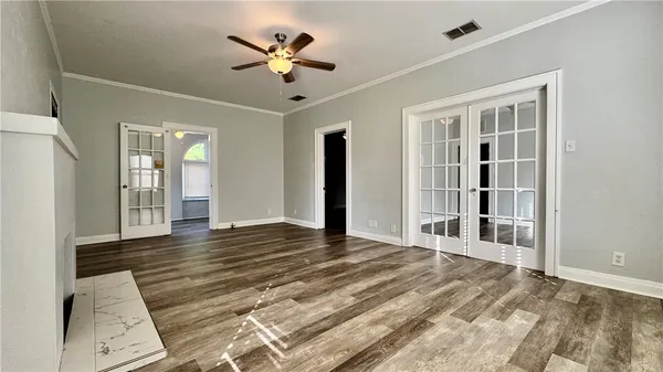 wooden floor in an empty room with a window