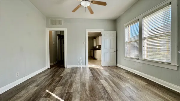 an empty room with wooden floor and a window
