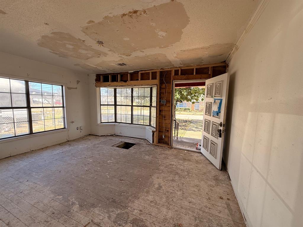 714 South Medora Street Terrell, TX 75160 - Photo 2 of 7 a view of an empty room with a fireplace and a window