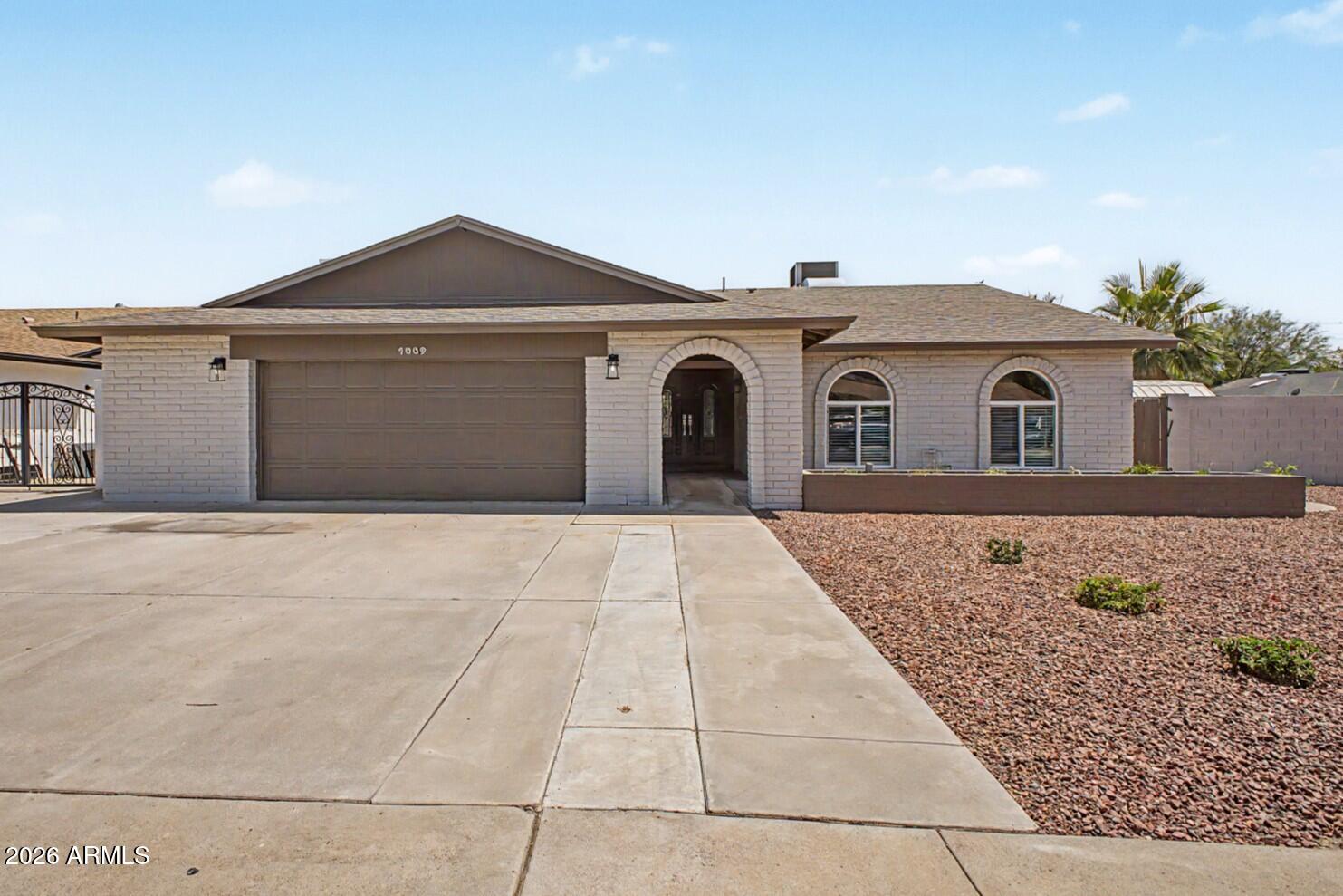 1009 West Pampa Avenue Mesa, AZ 85210 - Photo 1 of 31 a front view of a house with a yard