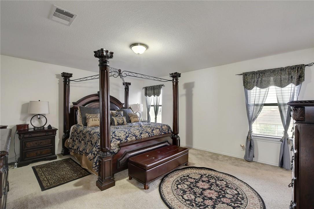 356 Matthews Kyle, TX 78640 - Photo 9 of 30 A spacious sleeping area offers comfort with plush carpeting and natural light.