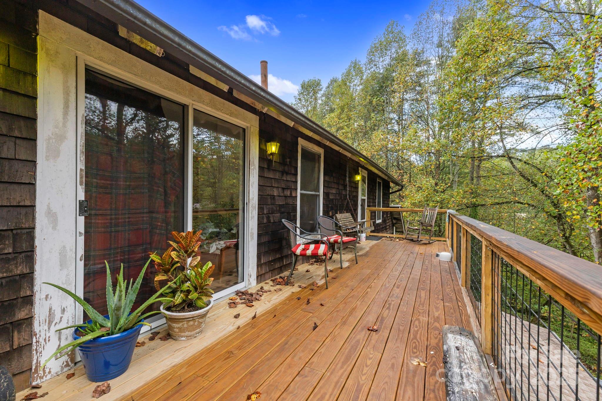 1196 North Country Club Road Brevard, NC 28712 - Photo 27 of 48 a view of a deck with wooden floor and outdoor seating